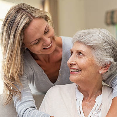 Woman embracing senior mother