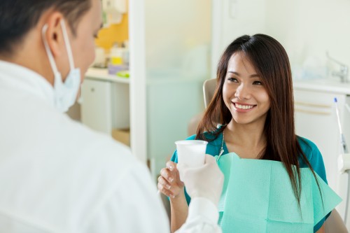 Dental Patient that is about to use the water cup