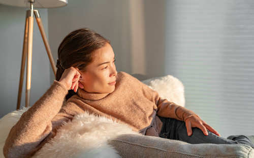 woman sitting while looking at the window