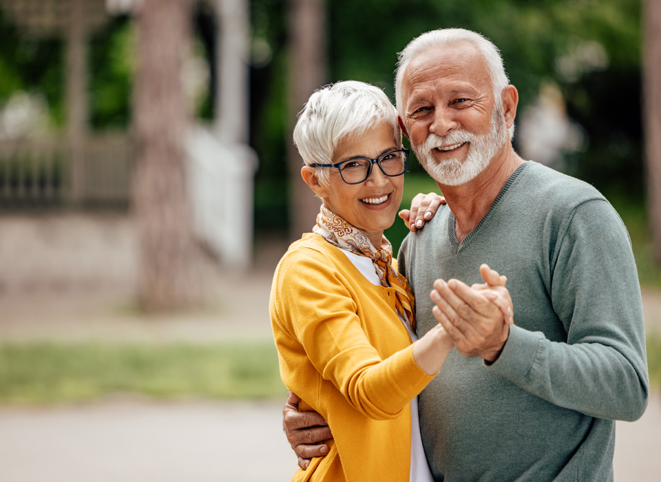 Portrait of senior couple, practicing their dance moves, while posing.