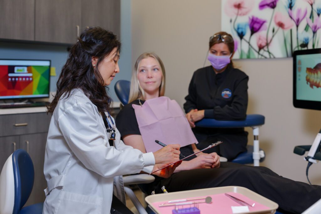 The dentist discussing the procedure to a patient